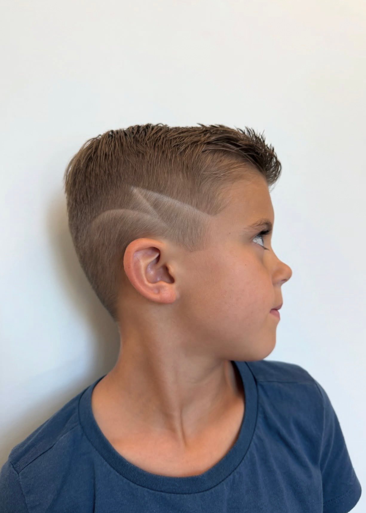 Boy's haircut with a shaved hair design
